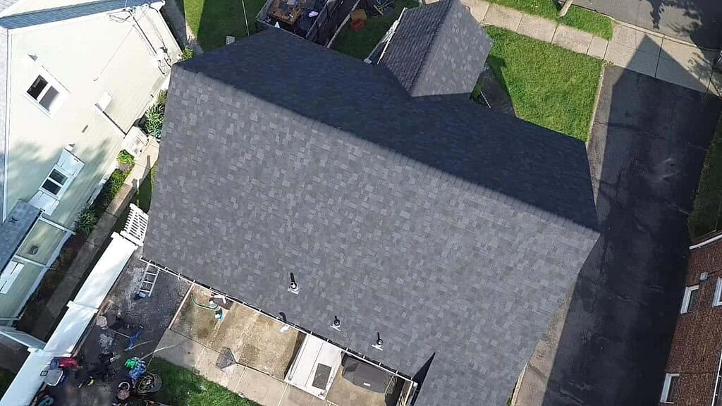 Aerial view of a finished dark gray asphalt shingle roof on a New Jersey home