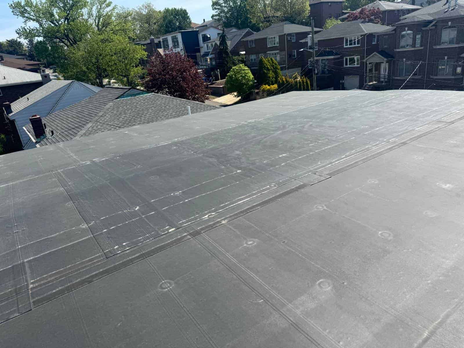 New flat roof membrane on a low-slope roof in a dense New Jersey neighborhood