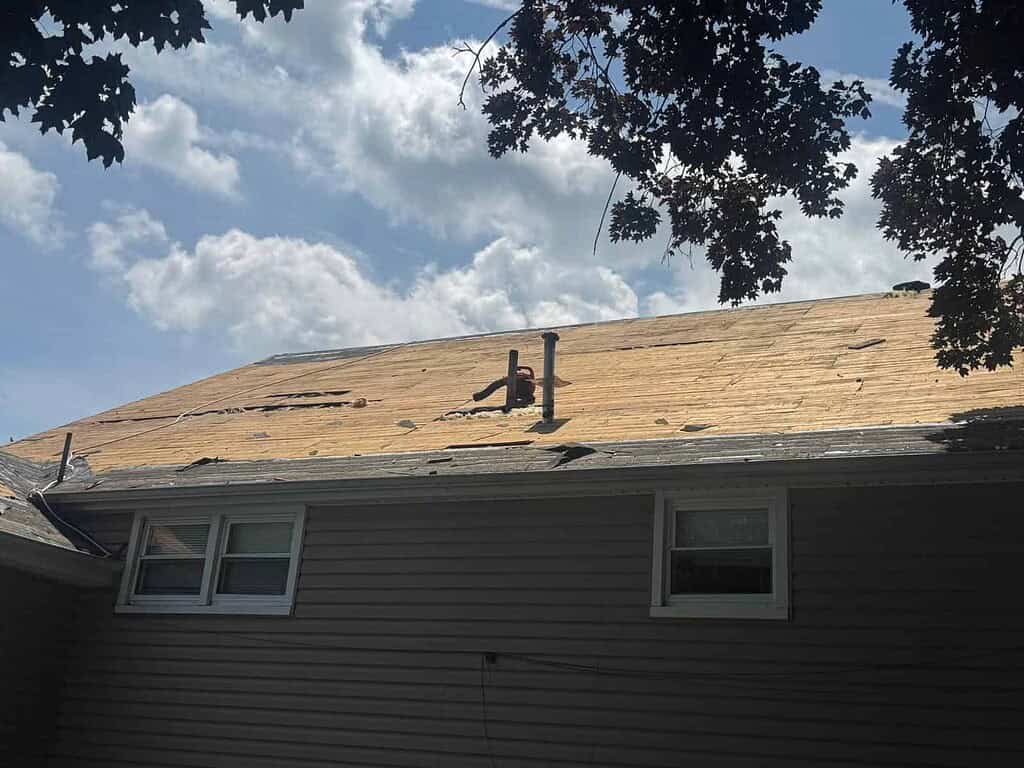 Old roof torn off down to the original boards on a New Jersey home, showing the roof deck before repairs