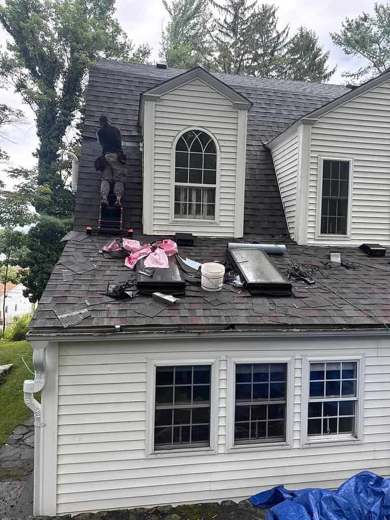 Skylight replacement in progress on a New Jersey home with dormers