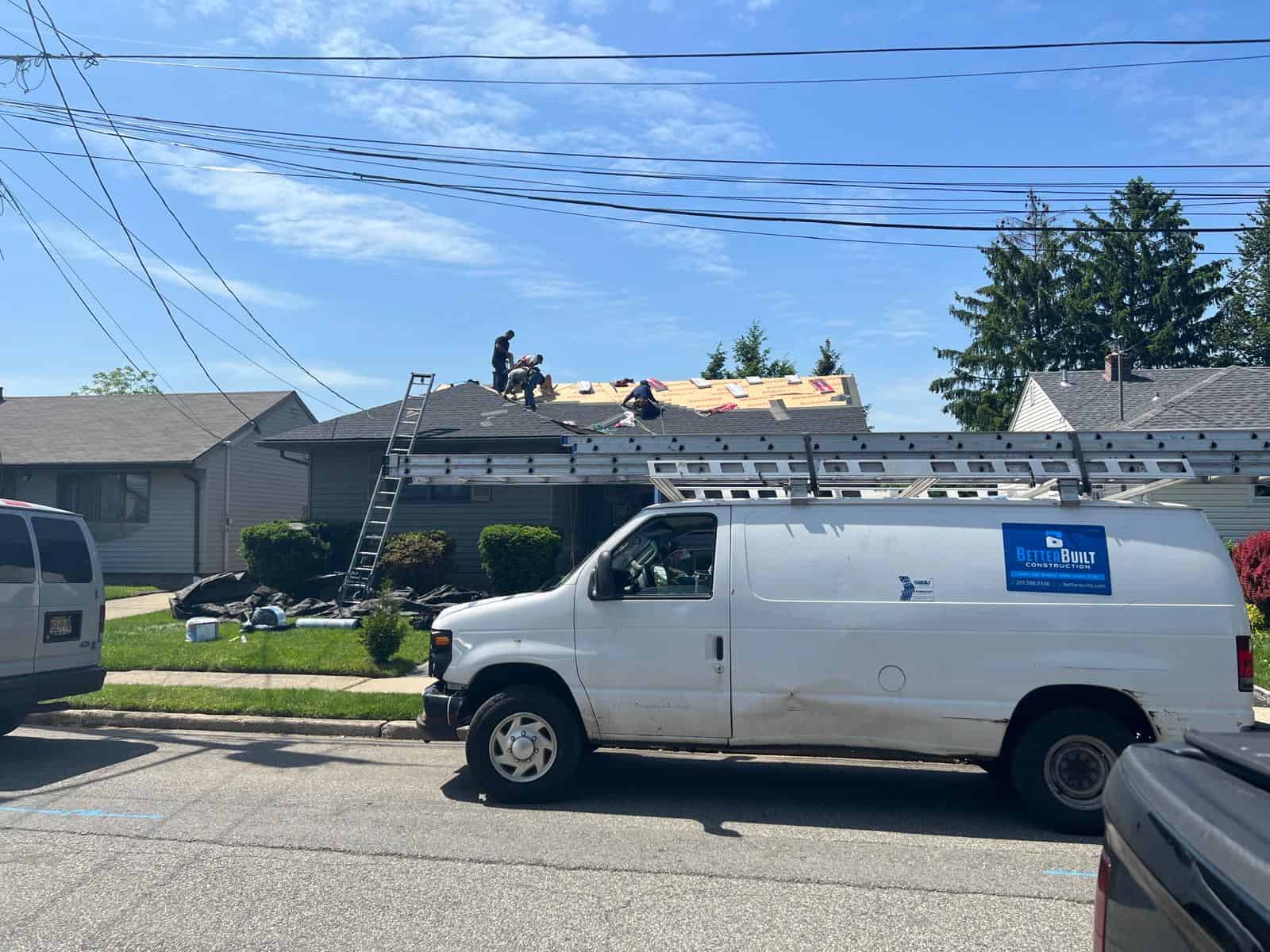 Better Build Construction van parked outside a New Jersey ranch home while the crew works on the roof