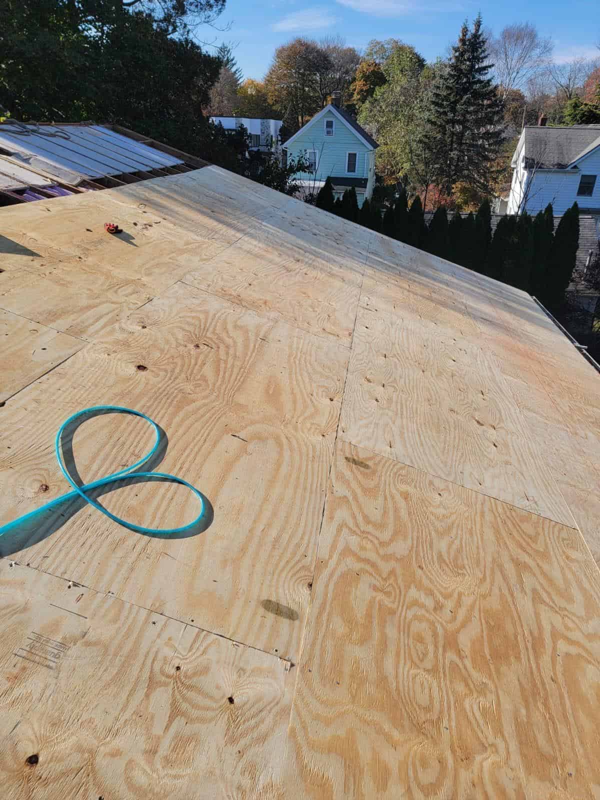New plywood decking installed on a low-slope New Jersey roof before the new roofing goes on